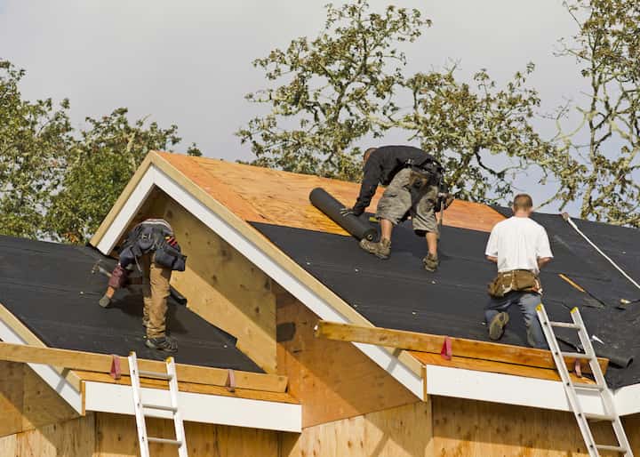 Roofing repair experts working on a residential home in Redonda Beach, FL.